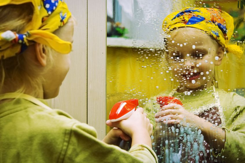 little girl cleans window