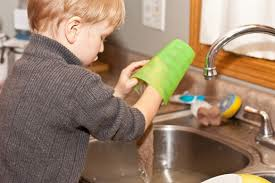 boy hand washing a cup with eco friendly cleaner
